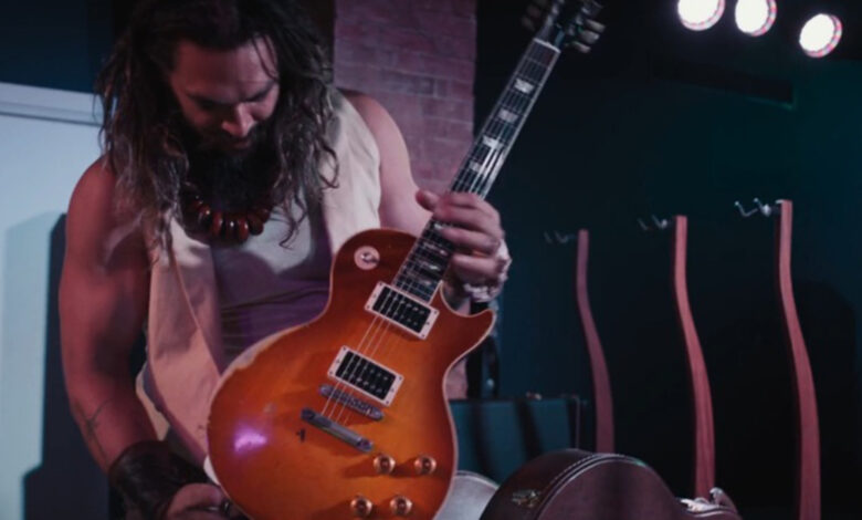 “The bass has been given the nickname ‘Momoa’s Koa’”: Jason Momoa is auctioning off a collection of Gibson and Fender Custom Shop guitars and handmade bass builds, including signed Slash and Billy Gibbons Les Pauls